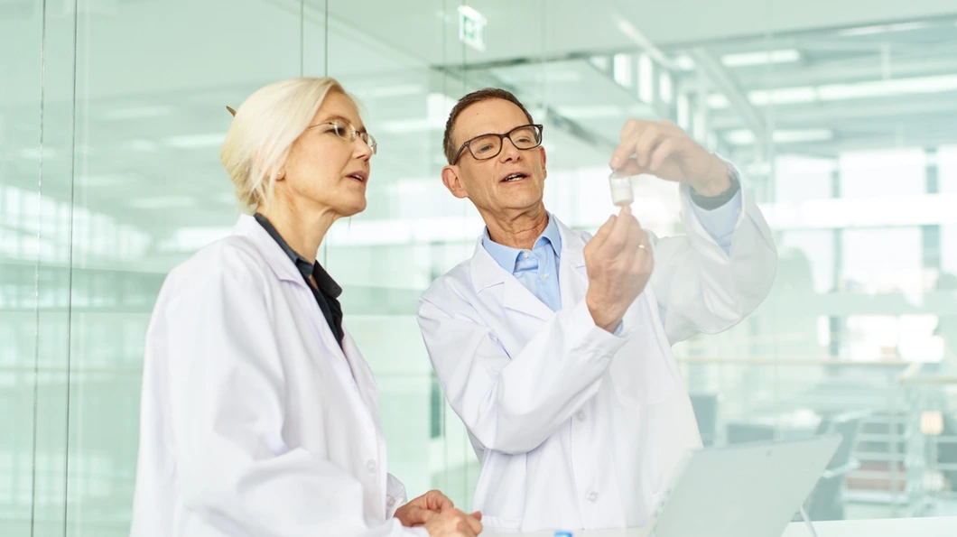 Researchers in a lab, looking at findings